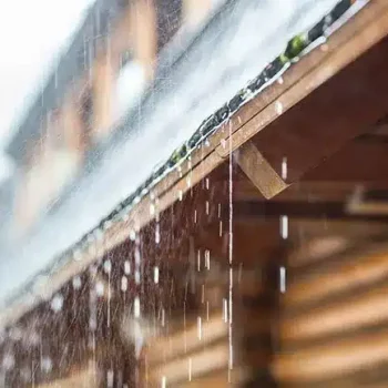 stormwater runoff from wooden roof on a log cabin style home