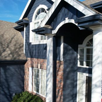 A finished home exterior with updated siding and trim, showing a top-rated siding installer in Omaha by Anchor Roofing.