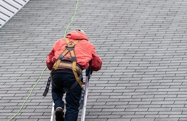 Contractor inspecting roof
